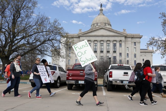 People march past the east side of the state Capitol April 9, 2018, the eighth day of a walkout by Oklahoma teachers, in Oklahoma City. While a work stoppage isn't the answer, guest columnist says, Oklahoma teachers have sufficient numbers for collective action to create “creative tension” against harmful legislation.
