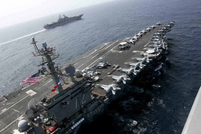 The aircraft carrier Abraham Lincoln sails in the Arabian Sea near the amphibious assault ship Kearsarge in 2012. [U.S. NAVY VIA AP]