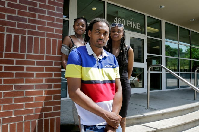 Gary Cleveland, a former resident of the Houston House, with his daughter Samantha Stone, right, and her mother, Talena Stone, in front of Amos House after graduating from the Amos House carpentry program recently. [The Providence Journal / Kris Craig]