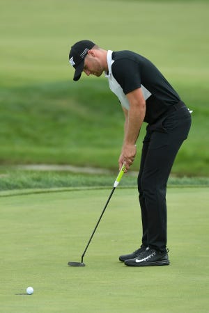 Wyndham Clark sinks a birdie putt on the 18th green during the third round of the 3M Open in Blaine, Minn., on Saturday. The former collegiate standout at Oregon shot a 64 on Saturday. [Aaron Lavinsky/Star Tribune via AP]