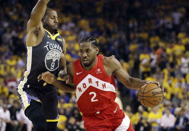 In this June 13, 2019, file photo, Toronto Raptors forward Kawhi Leonard (2) drives against Golden State Warriors forward Andre Iguodala (9) during the first half of Game 6 of the NBA Finals in Oakland, Calif. [The Associated Press / Ben Margot]