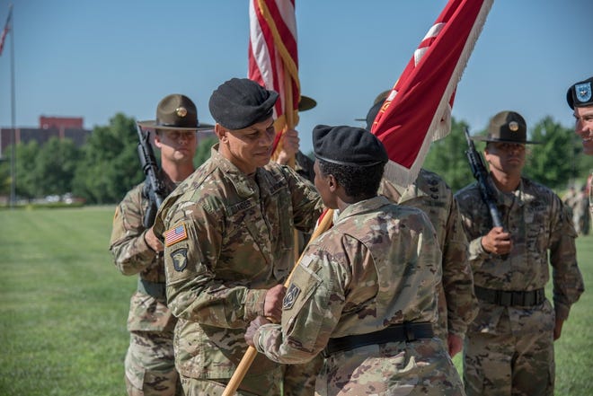 Col. Mark Quander, a Fayetteville native, receives the colors from Maj. Gen. Donna Martin, commander of U.S. Army Maneuver Support Center of Excellence and Fort Leonard Wood, during the U.S. Army Engineer School's Change of Commandant ceremony Tuesday at Fort Leonard Wood, Missouri. [Dawn Arden/Fort Leonard Wood]