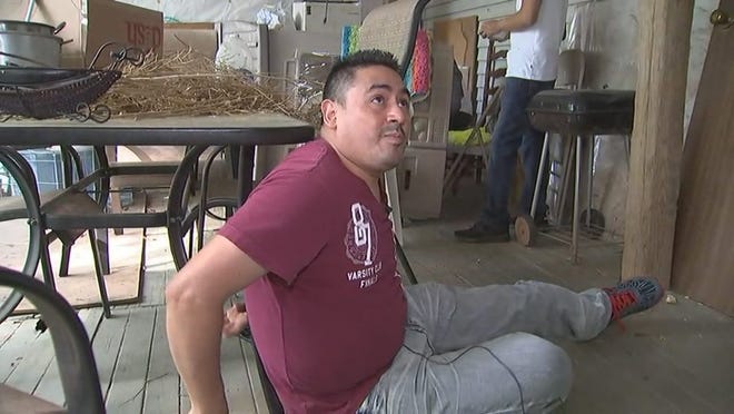 Gaston County resident Manuel Munoz Angeles demonstrates how a man broke into his home early Sunday morning and tied him up on his back porch while robbing him. [WSOC-TV]
