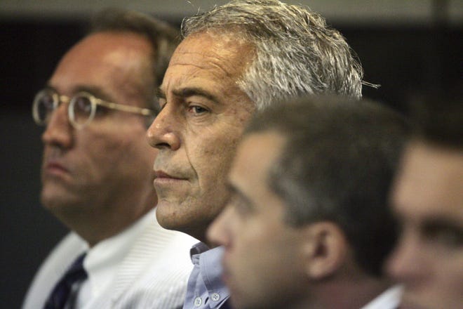 Jeffrey Epstein (center) is shown in a Palm Beach County courtroom on July 30, 2008, where he pleaded guilty to two prostitution charges. [UMA SANGHVI/PALMBEACHPOST.COM]
