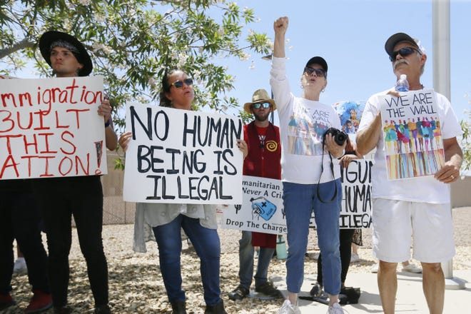 Protesters gather at the front of the Clint Border Patrol station to hear U.S. and Texas lawmakers talk about what they thought of the area facilities they toured in July . (Briana Sanchez / El Paso Times via AP)