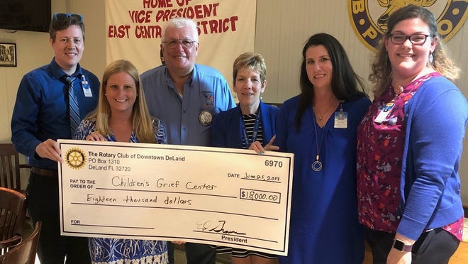 The Rotary Club of Downtown DeLand presents a donation to Begin Again's Children's Grief Center. (Photo provided)