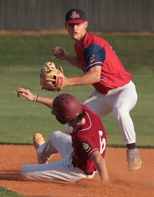 Gaston's Dosi Jonas attempts to complete the double play as Jarrett Penland is out at second as the Braves hosted Asheville in American Legion playoff action at South Point High School in Belmont Monday evening. [Mike Hensdill/The Gaston Gazette]