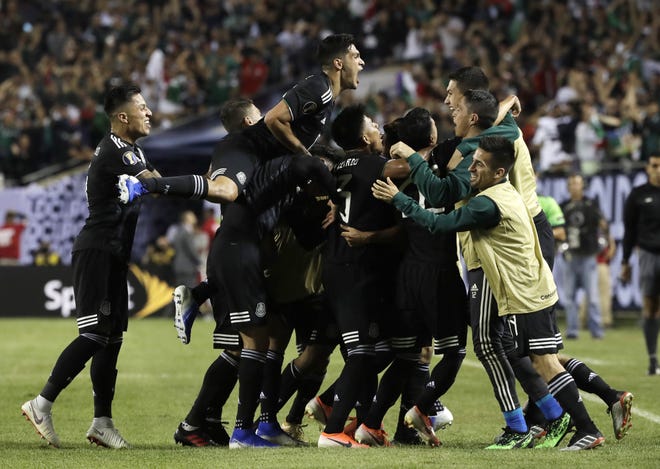 Mexico midfielder Jonathan Dos Santos (6) celebrates with teammates after scoring his first goal against the United States during the second half of the CONCACAF Gold Cup final soccer match in Chicago, Sunday, July 7, 2019. (AP Photo/Nam Y. Huh)