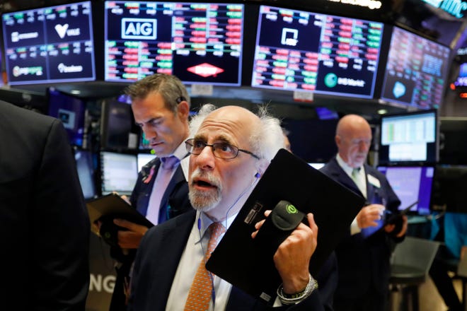 Trader Peter Tuchman works on the floor of the New York Stock Exchange Monday. Technology and health care companies drove U.S. stocks to a lower finish Monday as the market fell for a second straight day following a run of record highs. [AP Photo / Richard Drew]