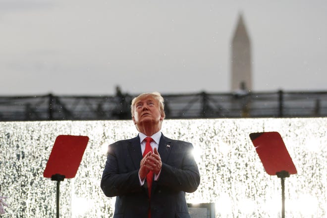President Donald Trump looks up during the military flyovers at the Independence Day celebration in front of the Lincoln Memorial, Thursday, July 4, 2019, in Washington. The Washington Monument is in the background. (AP Photo/Carolyn Kaster)