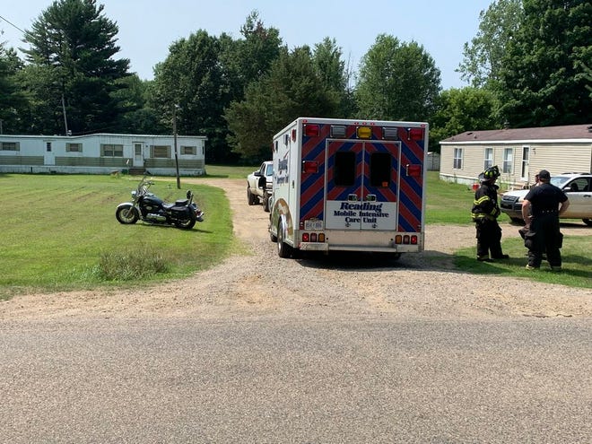 Litchfield firefighters standby as paramedics with Reading Emergency Unit evaluate a motorcycle rider who was struck by a deer Tuesday morning on Mosherville Road.