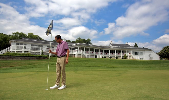 Golf Pro Conner Chitty checks greens at Cleveland Country Club on Friday. [Brittany Randolph/The Star]