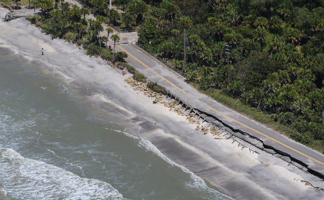 A section of North Beach Road on Manasota Key after Hurricane Irma damaged the pavement. A new report that highlights the fiscal threat that climate change poses to Southwest Florida estimates that Sarasota and Manatee counties will need more than $3 billion in new sea walls by 2040. [Herald-Tribune staff photo / Dan Wagner]