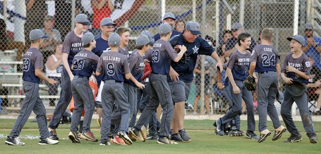 The North Port Little League All-Star team celebrates its 13-4 win over Sarasota National to win the District 16 Little League (11-12-year-olds) tournament at Twin Lakes Park in Sarasota on July 1. [Herald-Tribune staff photo / Dennis Maffezzoli]