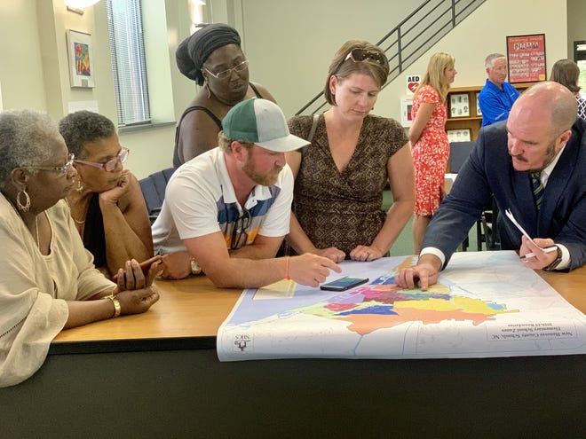Matthew Cropper (far right), president of Cropper GIS Consulting, speaks with community members that attended the first New Hanover County Board of Education redistricting commiteee meeting on Wednesday. From left to right: Florence Warren, Helen Johnson, Scott Burrell, Camelia Albright and Courtney Burrell. [JOEY CHANDLER/STARNEWS]