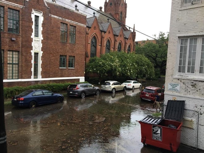 Many homes and businesses in New Orleans are already flooding ahead of what could become Hurricane Barry. In Uptown, an area that usually doesn't flood, a resident took it upon herself to unclog a catch basin, but not before some cars flooded. [MELANIE WARNER SPENCER]