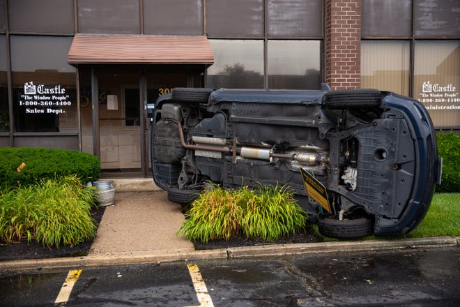 Stephanie Singleton’s vehicle was blown into the front of her workplace, Castle Windows on Gaither Drive in Mount Laurel, by a tornado that ripped through the parking lot on Saturday. Singleton was inside the building with co-workers; no one was injured. [DAVE HERNANDEZ / CORRESPONDENT]