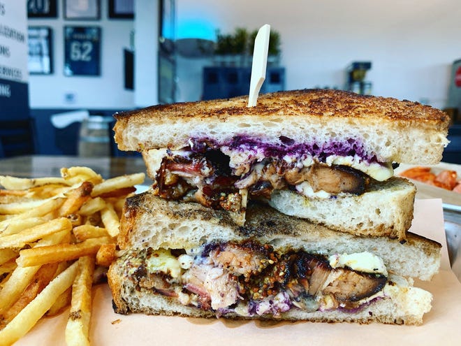 Strings' pork belly and brie grilled cheese on local Village Bread Company toast is slightly sweet due to local blueberry jam, and tangy thanks to grainy dijon mustard. [Caron Streibich/for the Times-Union]