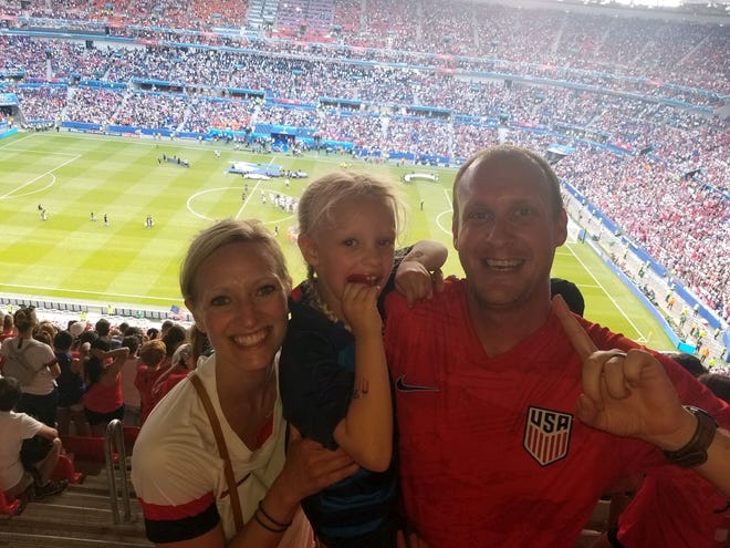 Winnacunnet High School girls soccer coach Nick O'Brien, right, with his wife, Katrina and their daughter, Ellie, celebrate after watching the United States women's national soccer team beat the Netherlands on Sunday in the World Cup final. [Courtesy photo]