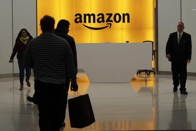 People walk into the lobby for Amazon offices Thursday, Feb. 14, 2019, in New York. [AP Photo/Mark Lennihan]