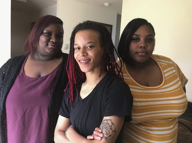 In this June 27, 2019 photo, LaMaya McGuire, 22, Jennifer McEwen, 25, and Sasha Collins, 27, all of Lansing, Mich., are shown. The women say a Delta Township Denny's ignored racial slurs directed at them by another patron. (Judy Putnam/Lansing State Journal via AP)