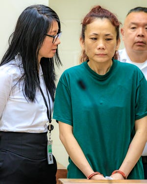 Huixian Liu, right, accused of fatally stabbing her husband stands before the judge during her Arraignment on murder at Quincy District Court on July 12, 2019. 

[E Gene Chambers/For The Patriot Ledger]
