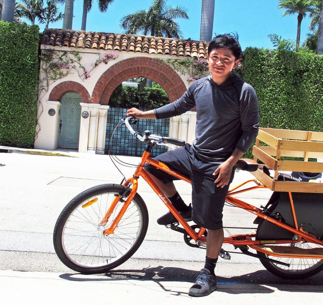 By bicycle, Andres "Andy" Perez Ramirez delivers lunches daily, except Sunday, throughout the Midtown area for Piccolo Mondo, a takeout-and-delivery sport in Via Mizner. [Photo by M.M. Cloutier]
