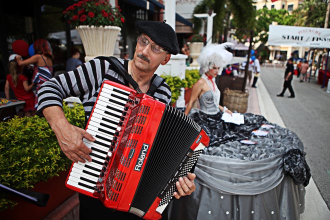 Larry Roberts plays tradition French music on his accordion in front of Pistache in downtown West Palm Beach during a Bastille Day celebration. The day is a commemoration of the storming of the Bastille fortress-prison, which was a symbol of the French Revolution. Pistache's ode to the French holiday features live music, wine, street performances, and a waiters' race.

(Brandon Kruse/The Palm Beach Post) SCR 2804