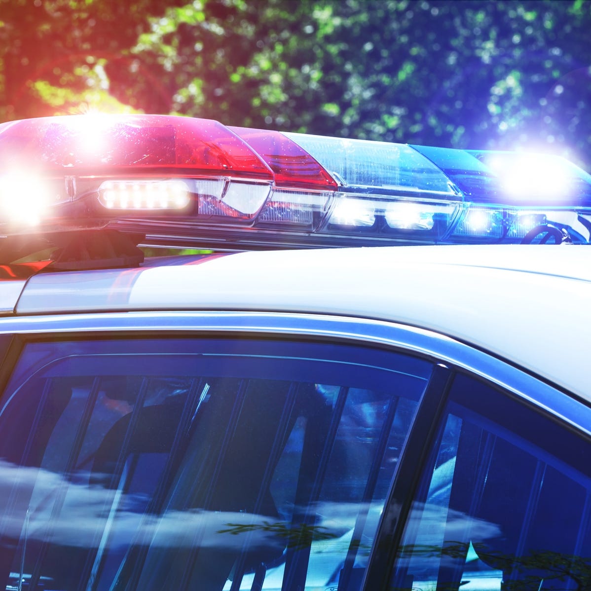 Police car with focus on siren lights. Beautiful siren lights activated in full mission activity. Policemen with patrol car in intervention operation at crime place. Emergency lights flashing on patrol car.