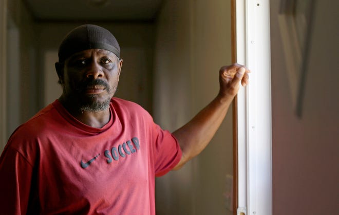 CORRECTS TO LESANE, NOT LESEUNE - In this photo taken Wednesday, May 29, 2019 resident James Lesane stands at the entrance to his mobile home in Lumberton, N.C. Every month, Lesane pays what he can afford for his mobile home lot rental_$150. But, after the Florida-based company Time Out Communities bought the park, he got a notice in the beginning of this year that his lot rent would be increasing to $465 a month. (AP Photo/Gerry Broome)