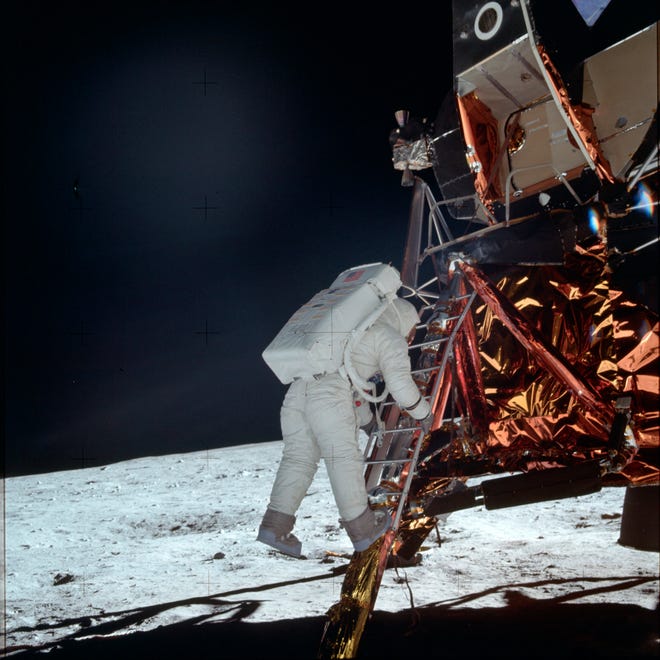 Astronaut Buzz Aldrin Jr. descends a ladder from the Lunar Module during the Apollo 11 mission. [NASA/Associated Press]
