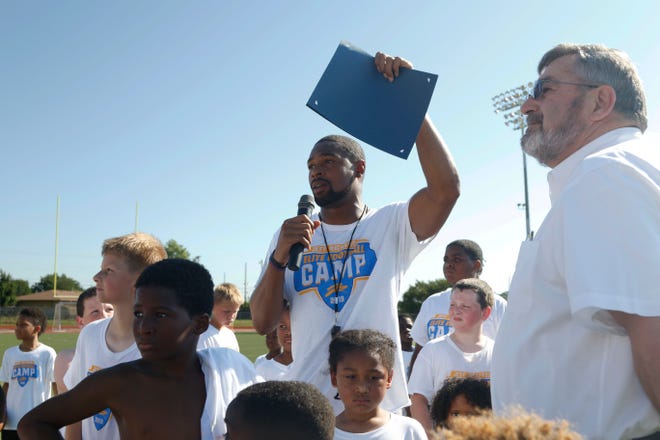 Los Angeles Chargers player Jeff Richards talks to the crowd after the declaration of July 13th as "Jeff Richards Day" in Del City as his elite football camp at Del City High School. [Paxson Haws/The Oklahoman]