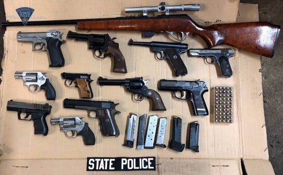 Guns seized in a state and local police raid in Holbrook. (State Police)