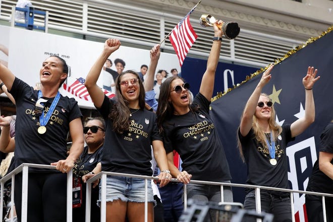 U.S. women's soccer team players Carli Lloyd, second from left, and Alex Morgan, second from right, celebrate with teammates in a parade along the Canyon of Heroes, Wednesday, July 10, 2019, in New York. The U.S. national team beat the Netherlands 2-0 to capture a record fourth Women's World Cup title. Wednesday, July 10, 2019.