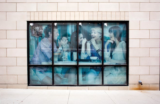 A wishful but weathered poster covers an empty storefront in the Highpoint development.