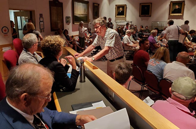 State Rep. Peter Somssich, D-Portsmouth, seen here before the public dialogue session on the McIntyre project Monday night, asked the people in City Council Chambers how many of them were opposed to the development plan. Almost everyone in the chamber raised their hand. [Jeff McMenemy/Seacoastonline]