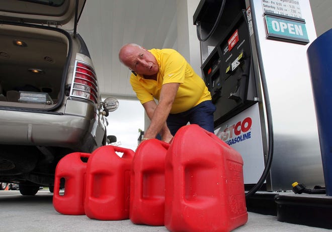 A customer fills up at the Costco in Royal Palm Beach. [ALLEN EYESTONE/palmbeachpost.com]