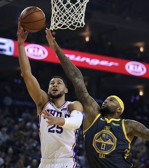 Philadelphia's Ben Simmons (25) goes to the basket during the first half of a Jan. 31 game against Golden State's DeMarcus Cousins in Oakland, Calif. [AP Photo/Ben Margot]