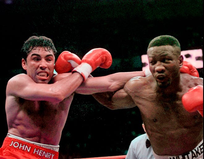Oscar De La Hoya and Pernell Whitaker, right, exchange punches during their WBC Welterweight Championship fight at Thomas & Mack Center on April 12, 1997, in Las Vegas. Former boxing champion Pernell Whitaker has died after he was hit by a car in Virginia. He was 55. Police in Virginia Beach on Monday say Whitaker was a pedestrian when struck by the car Sunday night. The driver remained on the scene, where Whitaker was pronounced dead. [Bob Galbraith/The Associated Press]