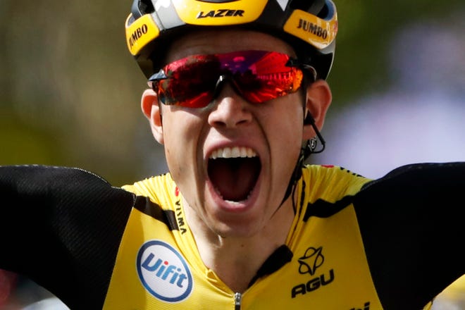 Belgium's Wout Van Aert celebrates as he crosses the finish line to win Stage 10 of the Tour de France. Monday's stage was 217 kilometers (135 miles) with the start in Saint-Flour and finish in Albi, France. [THE ASSOCIATED PRESS / THIBAULT CAMUS]