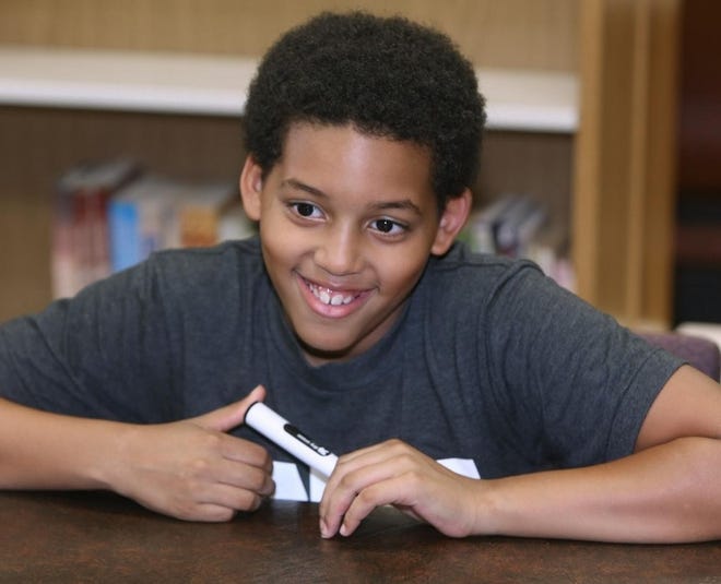 Darryl Elijah Owens III, 10, is the youngest student to attend Stark State College. He is one of 27 homeschooled students who learn together at Cross Over Academy, which holds its classes at the Martin Center in Canton. [SCOTT HECKEL/CANTON REPOSITORY]