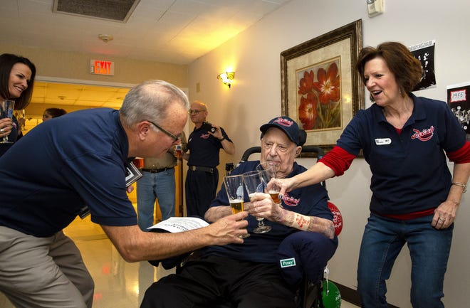 George Reisch and his sister, Kay, toast their dad, Ed Reisch, with Reisch Gold Top beer to celebrate his 100th birthday in March at a health care facility near St. Louis. [Rich Saal/The State Journal-Register]