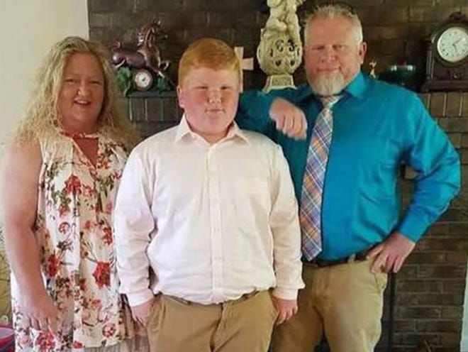 John Morgan Rogers, 14, pictured with his mother Kristi and father Marty, is hospitalized in Atlanta with a serious head injury, sustained Monday in a 4-wheeler accident. [Special to The Times]