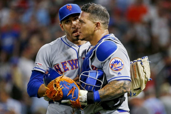 Mets closer Edwin Diaz and catcher Wilson Ramos celebrate after Diaz got Nelson Cruz to pop out with the bases loaded in the ninth. [THE ASSOCIATED PRESS]