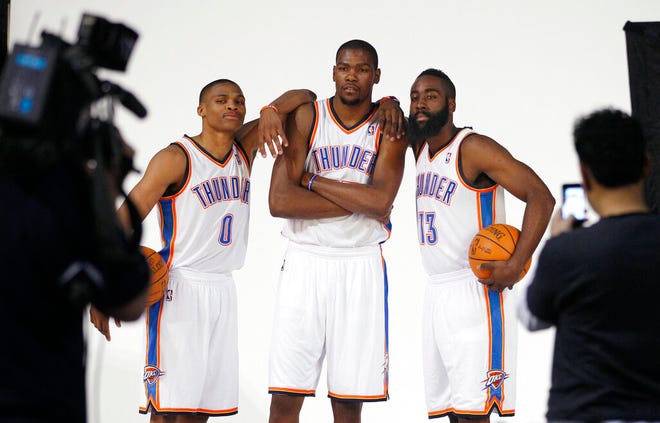From Dec. 13, 2011, Oklahoma City Thunder's Russell Westbrook (0), Kevin Durant, center, and James Harden (13) pose for a photo for NBA basketball photographers during media day in Oklahoma City. The Thunder are heading into a major transition. Westbrook was the last remaining player from the team that moved from Seattle to Oklahoma City in 2008. Durant, Harden, Serge Ibaka, Paul George and others are all gone. Now Westbrook will soon be on his way to Houston after an 11-year career with the franchise. (AP Photo/Sue Ogrocki, File)