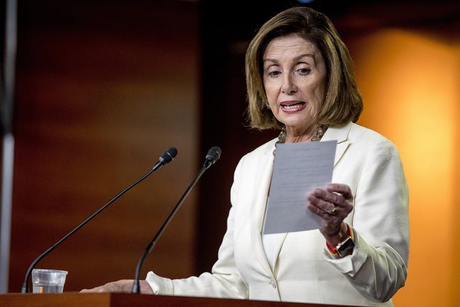 House Speaker Nancy Pelosi of Calif. reads from a paper titled "Know Your Rights" regarding ICE agents attempting to perform raids as she meets with reporters on Capitol Hill in Washington Thursday. [ANDREW HARNIK/ASSOCIATED PRESS]