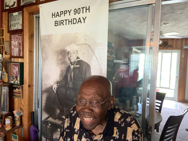 Eddie Shannon, 97, stands in front of a poster with an image of himself when he served in the Navy during the war. The poster was presented to Shannon on his 90th birthday and currently hangs in his Palmetto home. [HERALD-TRIBUNE PHOTO / CHRIS ANDERSON]
