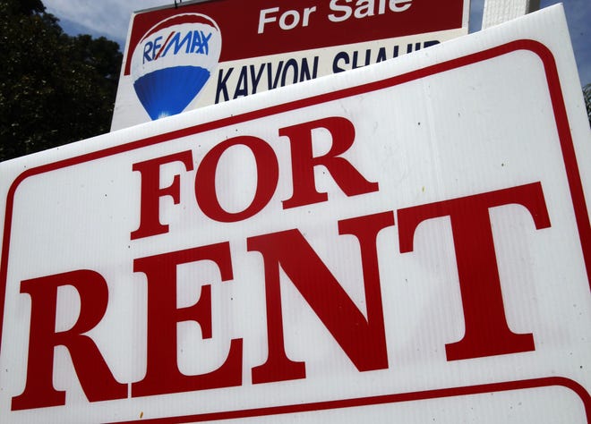 A "For Rent" sign sits in front of a home. [AP Photo/Reed Saxon/File]