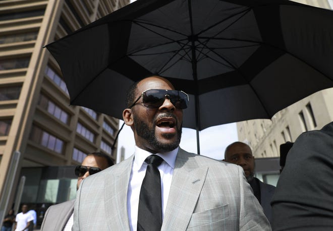 Musician R. Kelly departs the Leighton Criminal Court building in June after pleading not guilty to 11 additional sex-related charges in Chicago. A U.S. Attorney's office spokesman says Kelly was arrested last Thursday night on federal sex-crime charges in Chicago. [AP FILE PHOTO BY AMR ALFIKY]