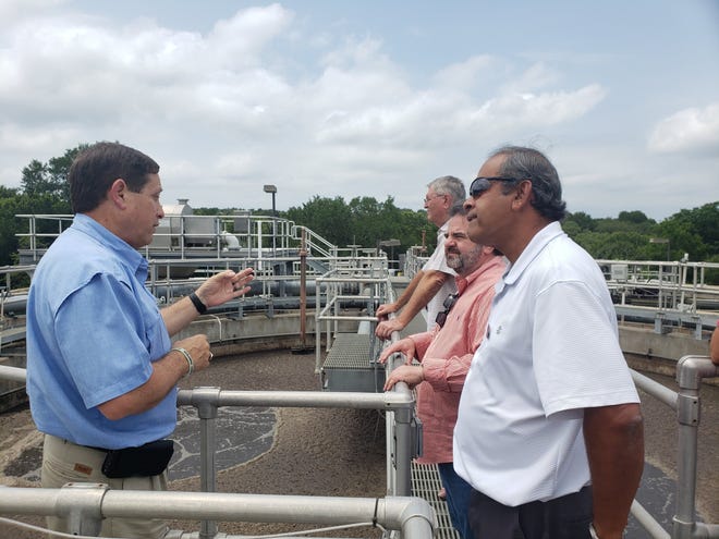 Lakeway Municipal Utility District General Manager Earl Foster at the wastewater treatment plant speaks with council members Sanjeev Kumar and Louis Mastrangelo. [Photo courtesy LMUD]
